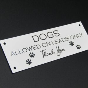 Dogs allowed on leads wall sign
